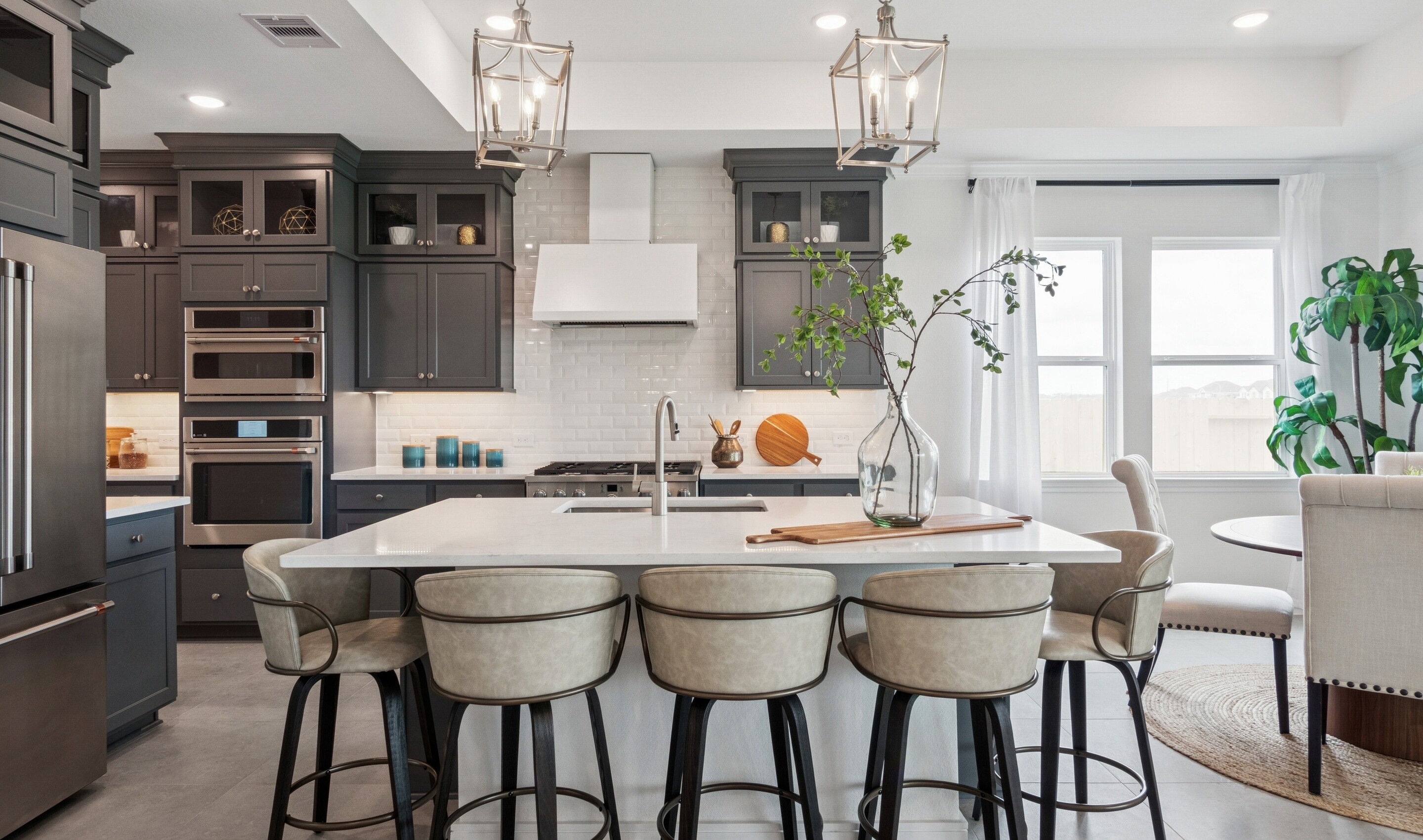 Kitchen with stacked glass-front upper cabinets