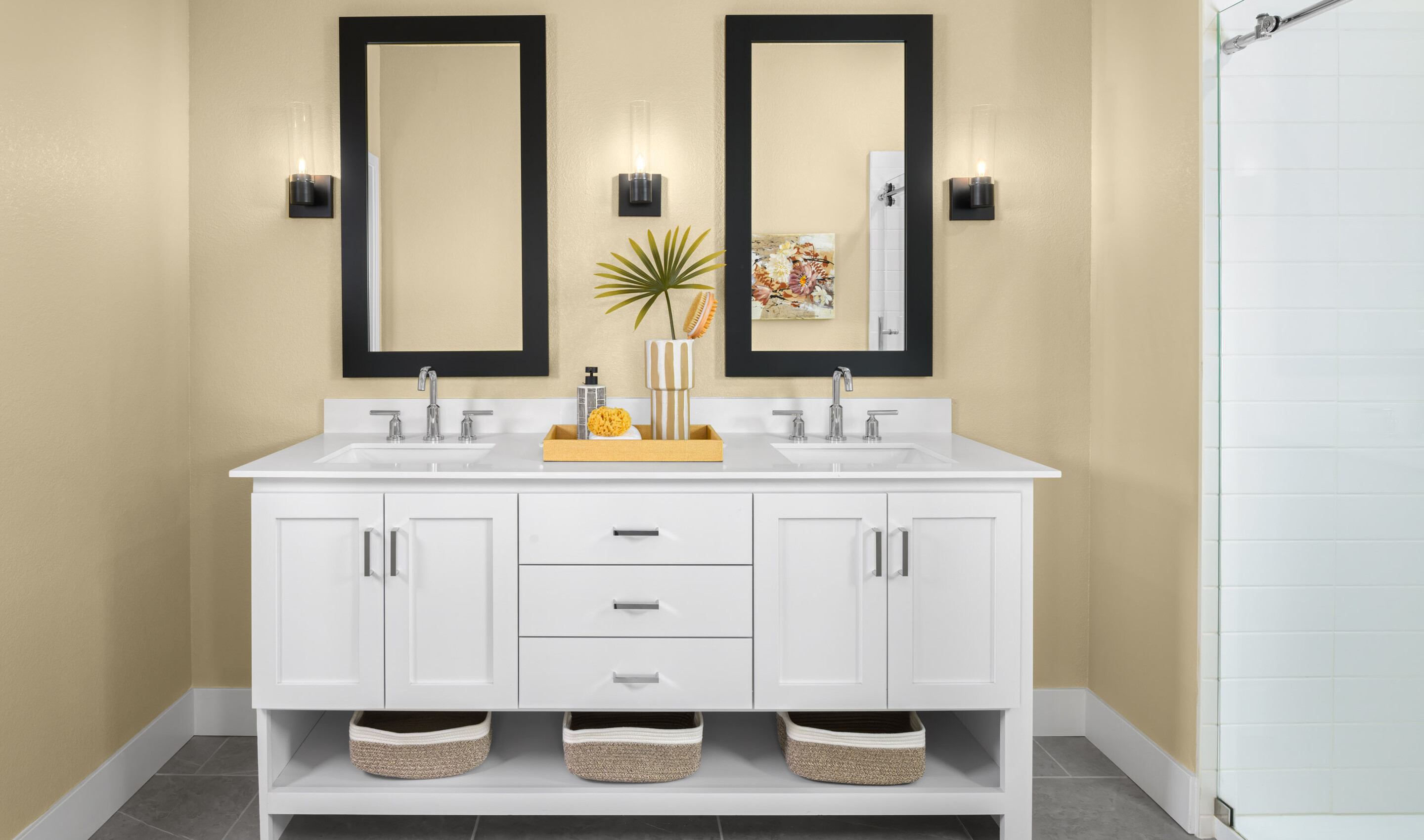 Primary suite freestanding vanity and glass shower enclosure