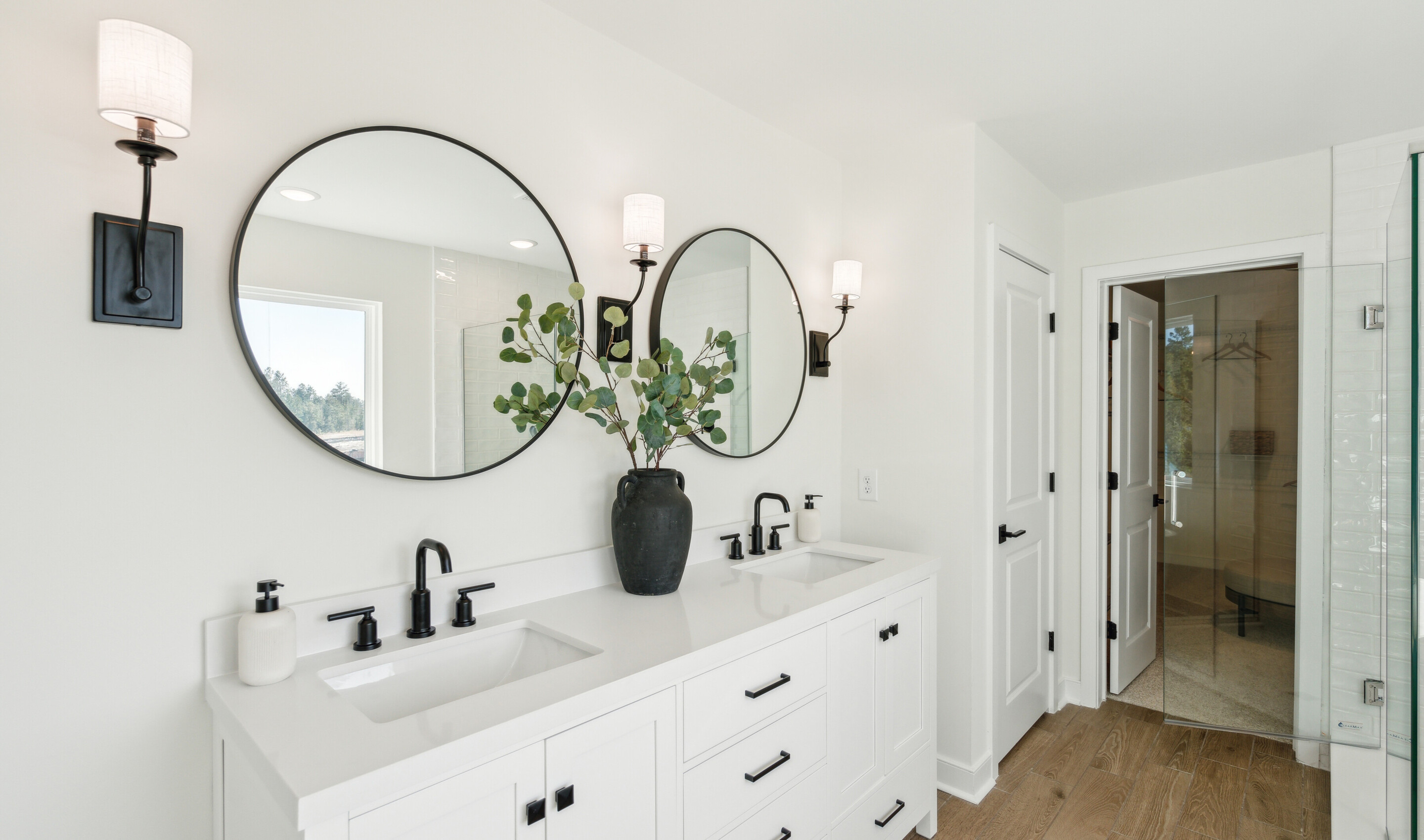 Primary bath features freestanding vanity with dual sinks