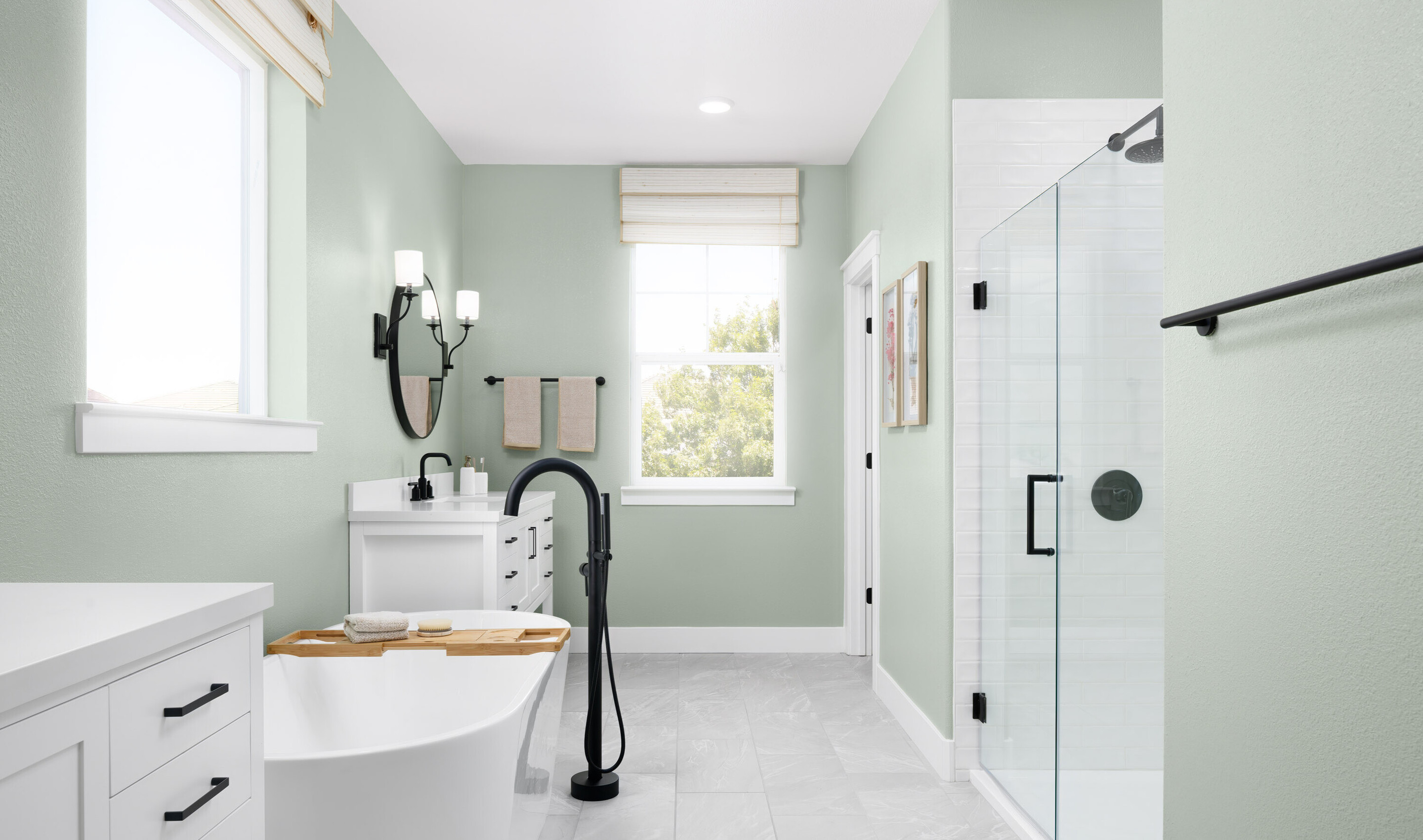 Glass shower enclosure with stylish tile and matte black fixtures